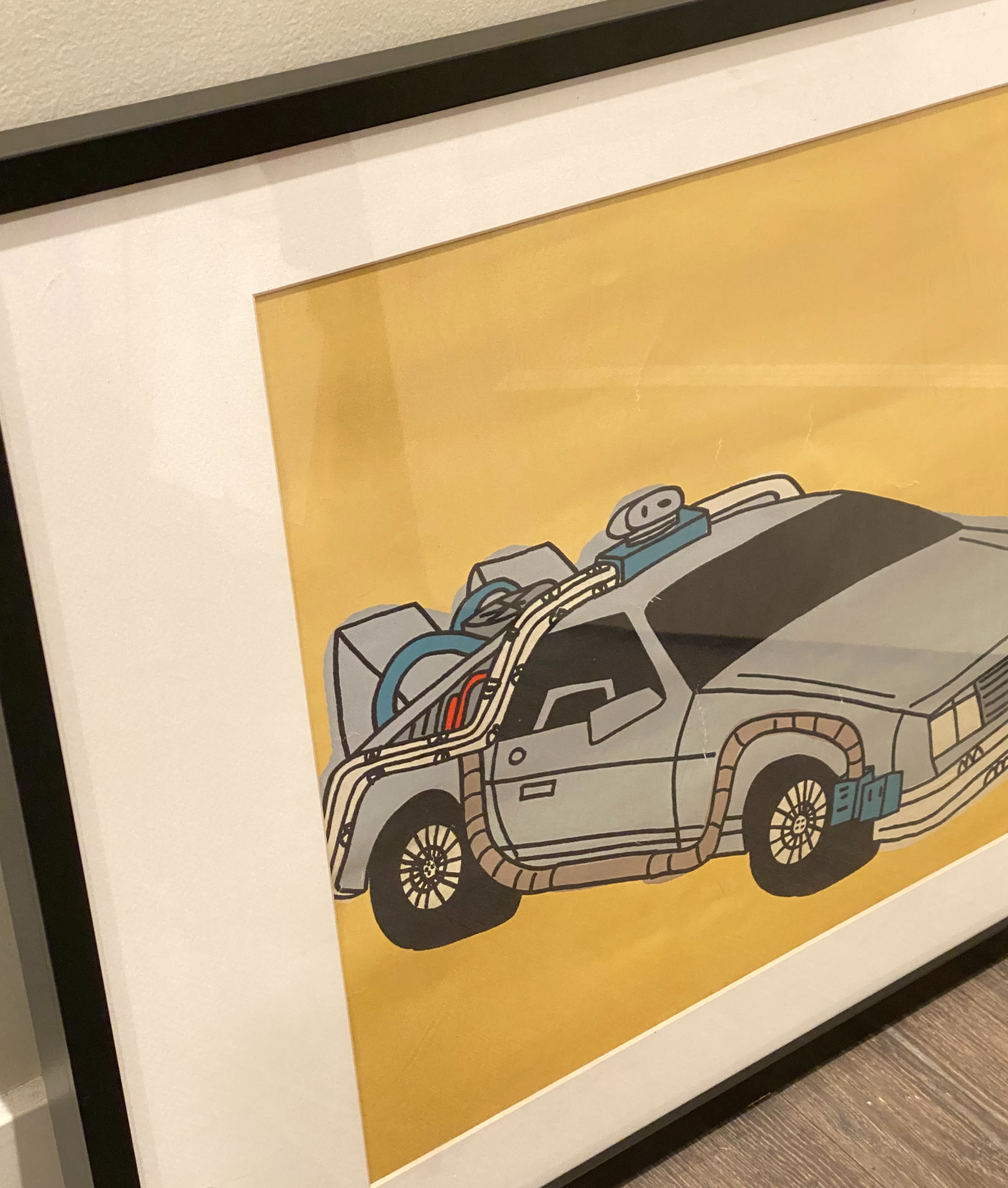 Rare Marz Jr. signed pop art of DMC DeLorean, framed and colorful, showcasing nostalgic design.